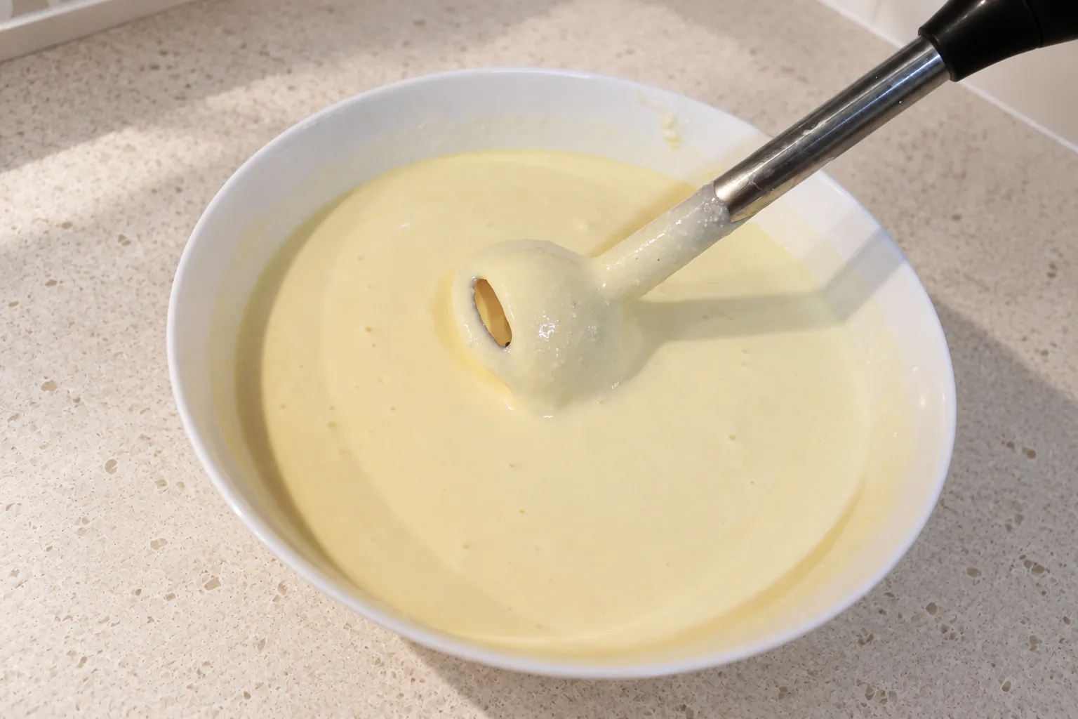 Smooth cottage-cheese, egg and yoghurt base with an immersion blender in the bowl