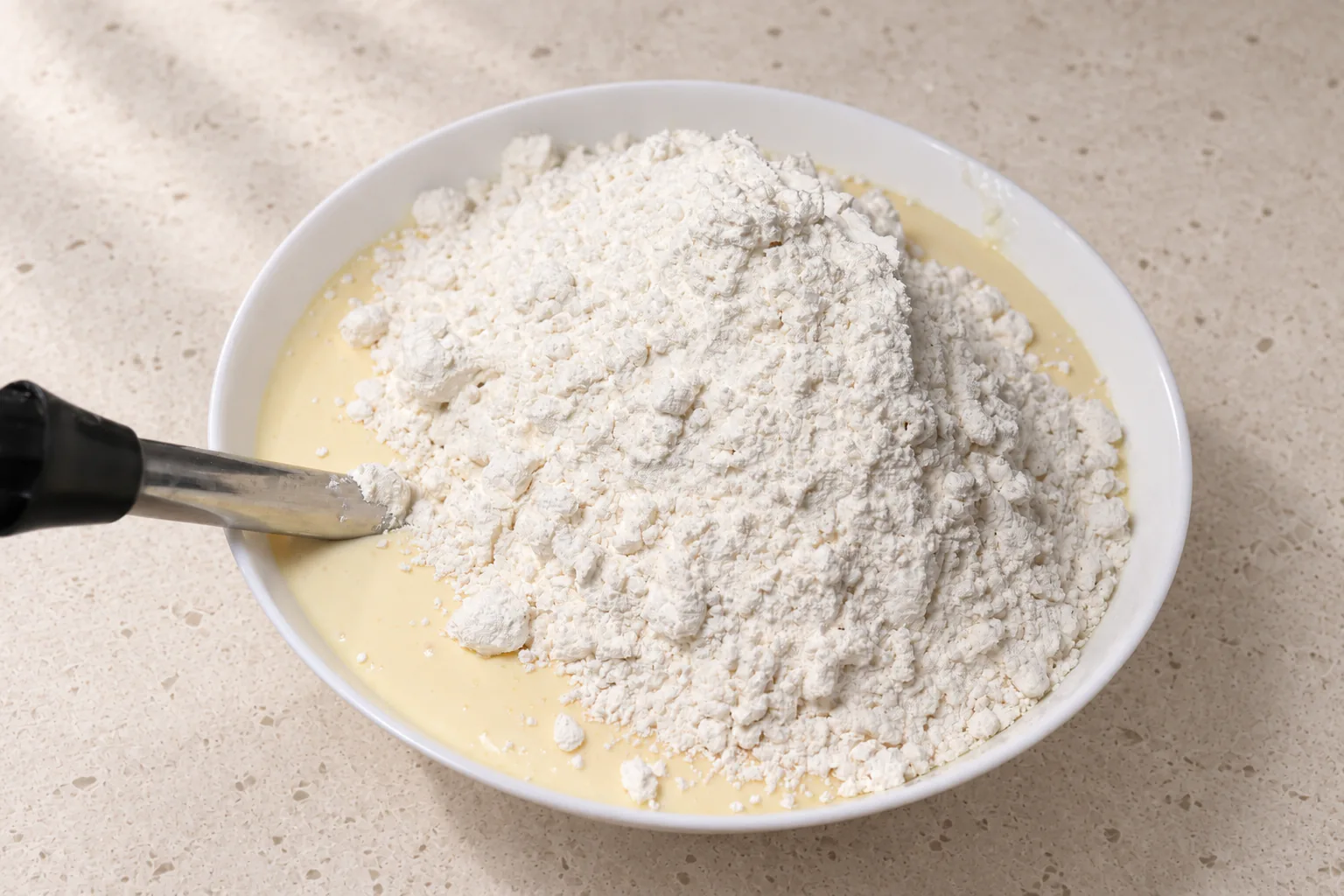 Gluten-free flour added to the wet waffle base before mixing