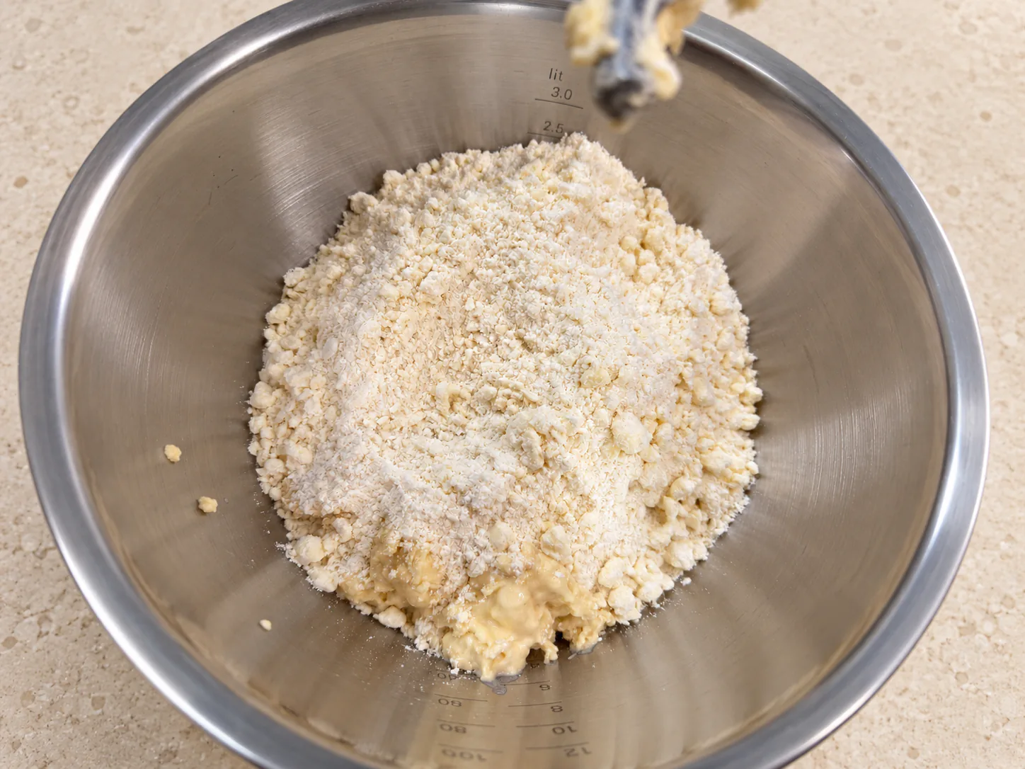 Butter and flour crumbs added to the wet dough in the mixer bowl