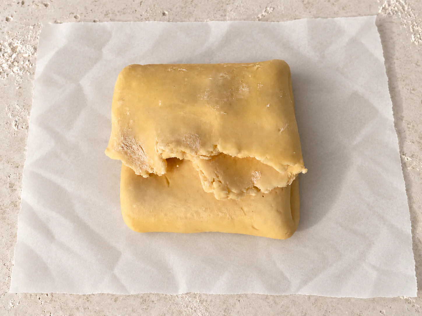 Dough folded into a square before rolling again