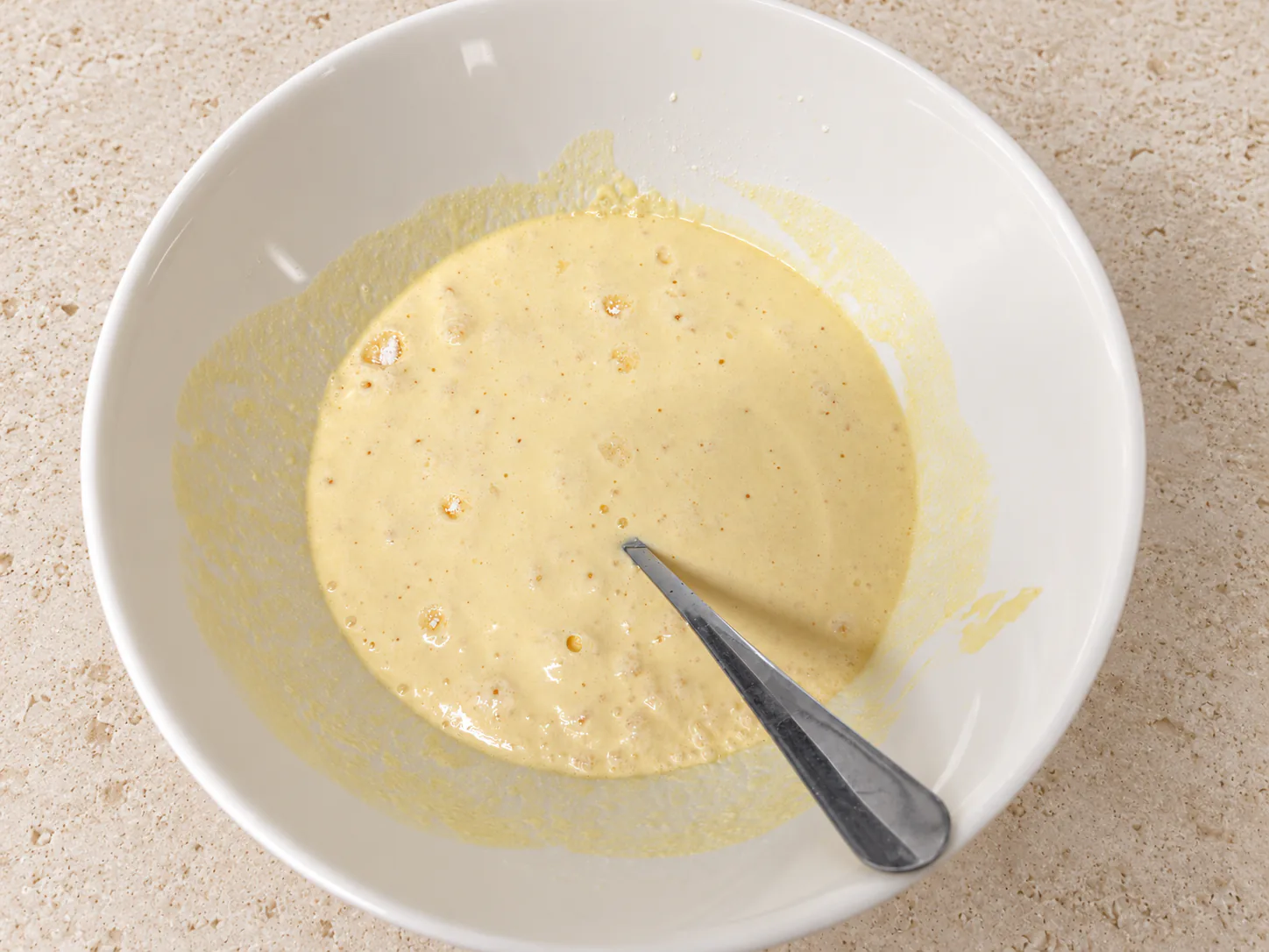 Bubbles on the surface of the sour cream and egg mixture