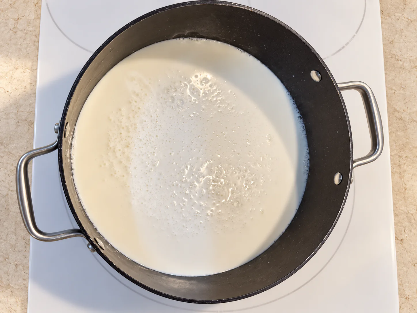Milk in the saucepan for the custard