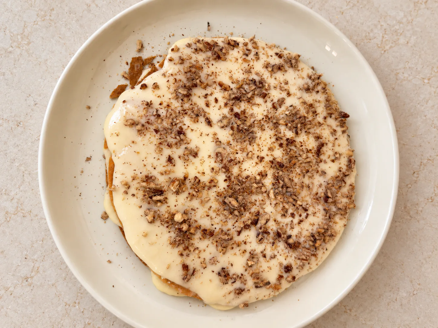 Pastry layer with custard and chopped nuts