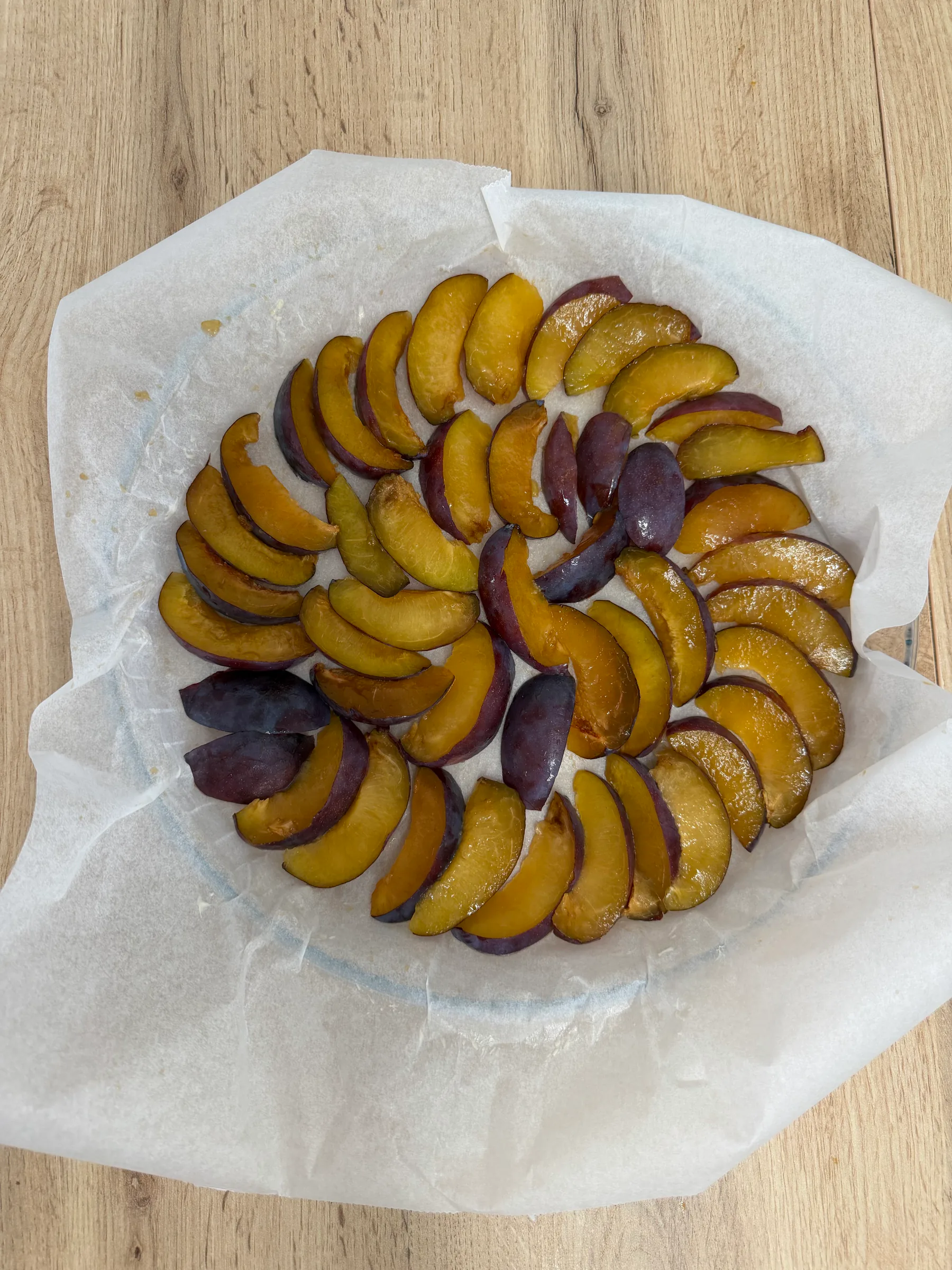 Plum wedges on buttered parchment