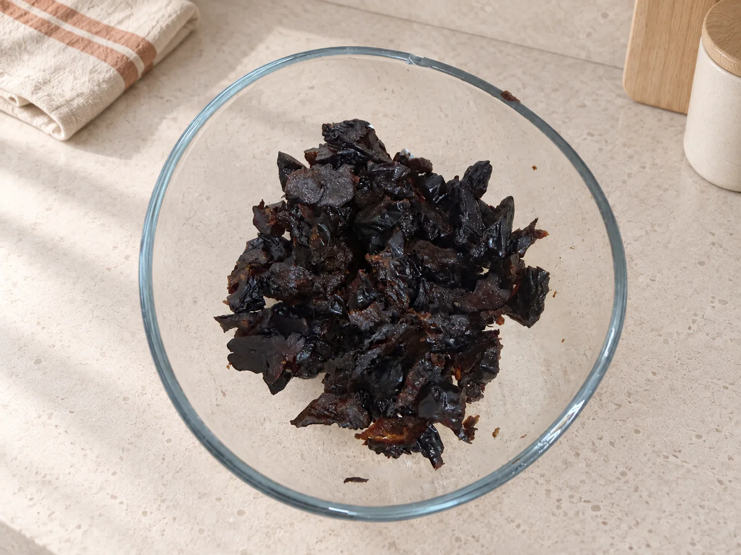 Chopped prunes in a glass bowl